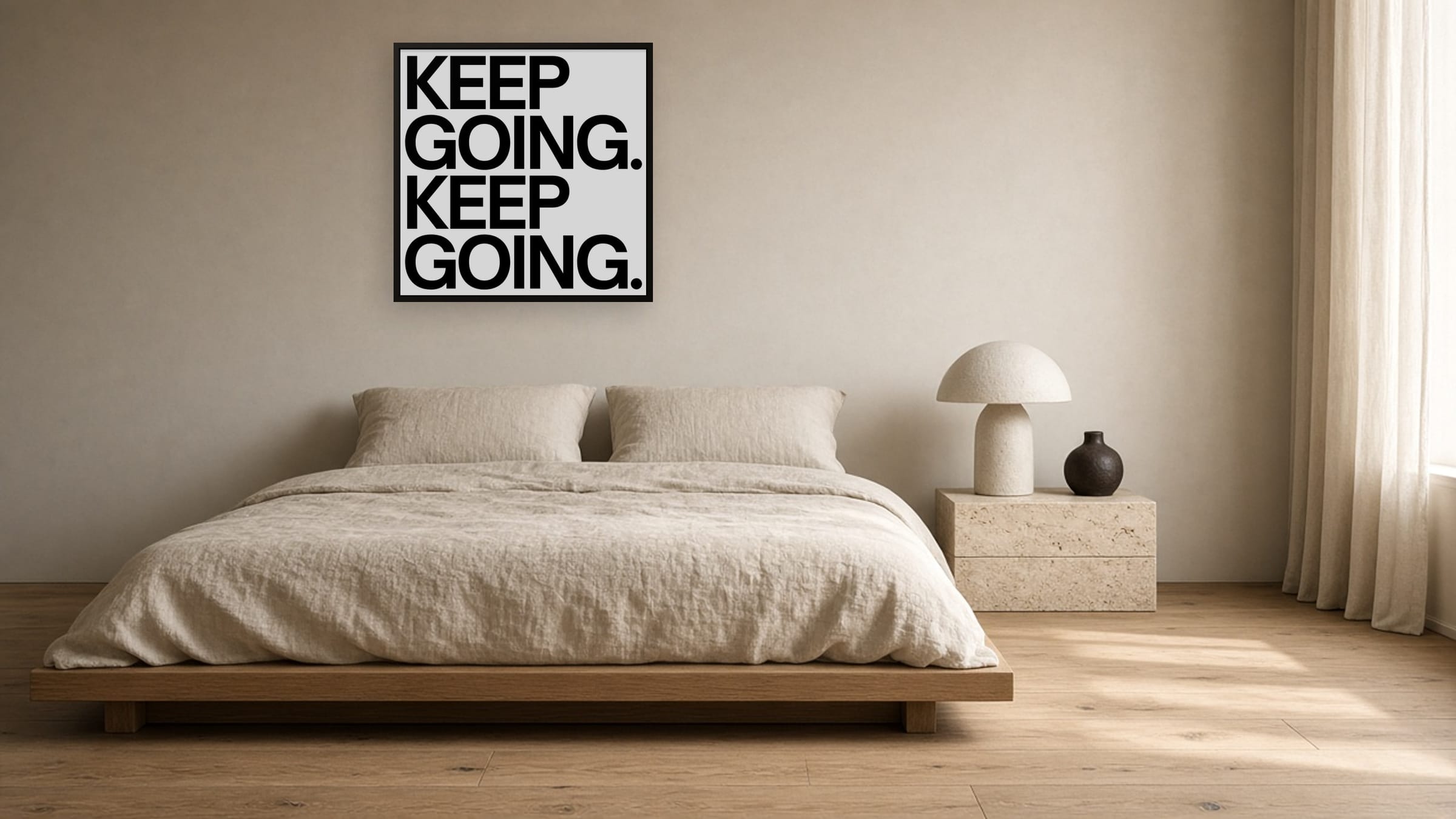Keep Going framed canvas hung above a low oak platform bed with washed linen bedding.