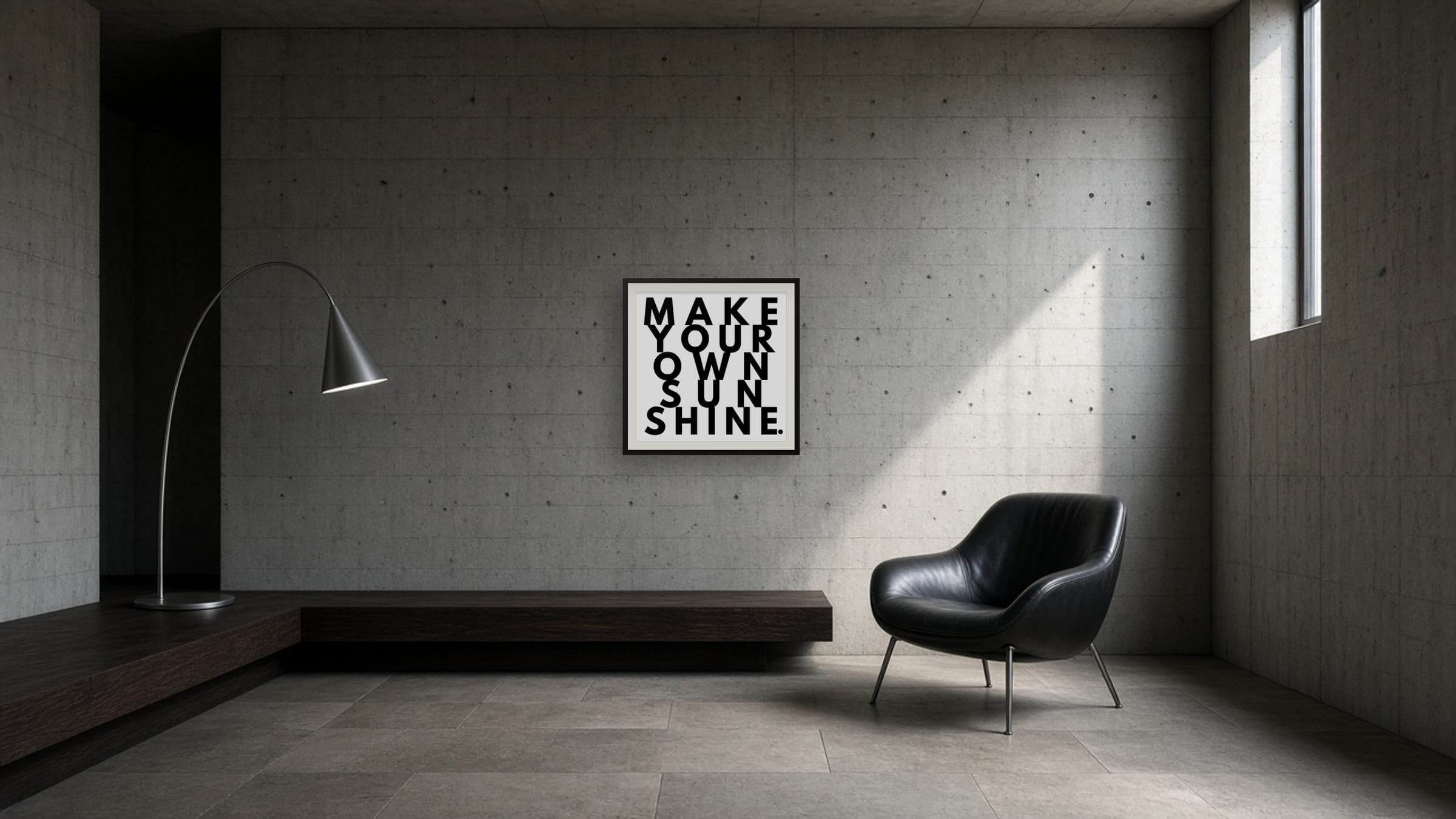 Make Your Own Sunshine framed print on a board-formed concrete wall in a brutalist living space with a black leather chair.